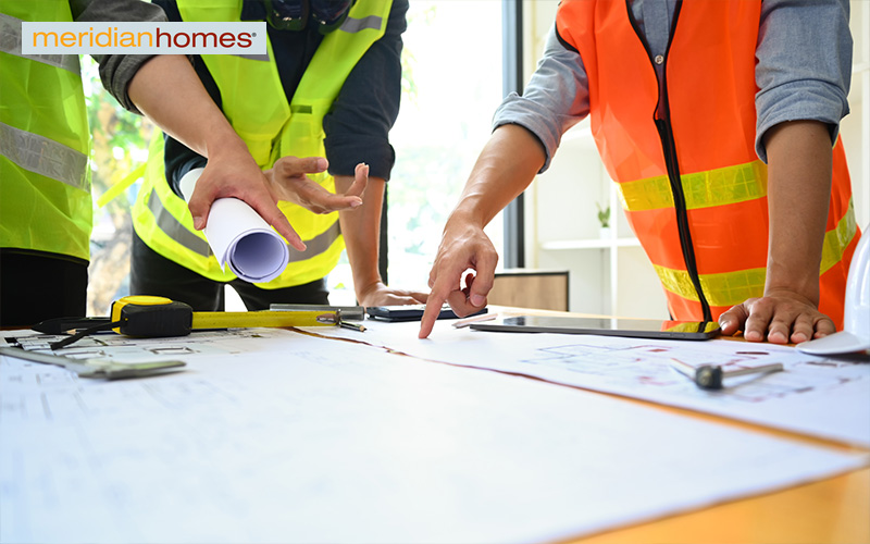 Contractors discussing the construction process.